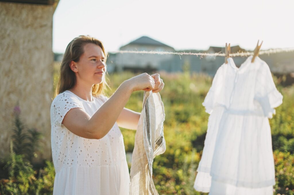 Young woman in white dress in country side at sunset